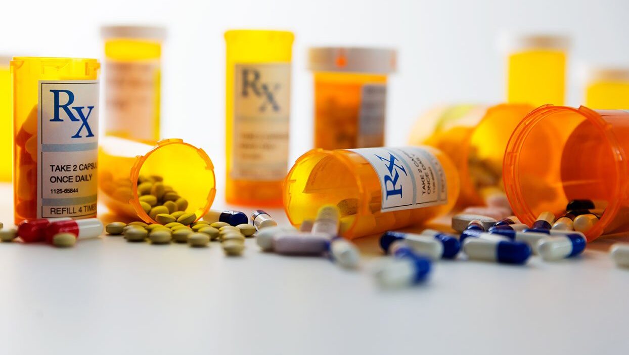 Multiple pill bottles spilled on the counter